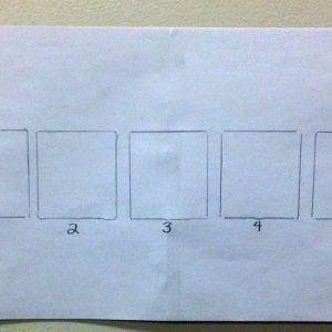 Hand-drawn prototype of the story squares activity with numbered drawing boxes sketched in pencil on a sheet of paper